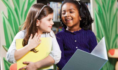 Young girls are all smiles as they learn together 